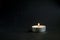 Background of sorrows lonely candle on a dark black texture