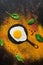 Background spices, fried egg, silhouette of the pan. Top view, flat lay. To the concept of food