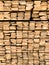 Background of the square ends of the wooden bars. Wood timber construction material for background and texture. close up. Stack o.