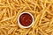 Background of stack of crispy french fries and ketchup.