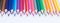 Background of stationery, colored pencils in a row