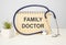 background a stethoscope with yellow list for you text FAMILY DOCTOR