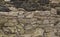 Background stone wall cobblestone gray weathered black pattern