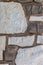 Background with stone wall with irregular sized white and brown slates