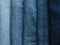 Background from strips of fabric of blue jeans of different shad