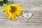 Background with sunflower, lock-heart and key on a old wooden bo