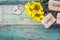 Background with sunflowers, gift boxes, heart-lock and key on old wooden boards with peeling paint. Space for text.