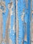 Background texture blue broken paint on old garage wooden boards