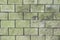 Background texture of a brick wall of light green, greenish shades of large blocks