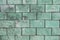 Background texture of a brick wall of poisonous green, greenish shades of large blocks