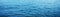 Background texture of a calm deep blue ocean with ripples on the surface of the sea water