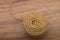 Background texture of a circle of a coil of natural hemp rope on a wooden table