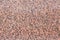 Background texture of deep pink granite in a polished slab