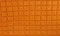 Background texture of knitted orange squares for the desktop