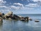 Background texture: large stones of various shapes in the sea. A pile of granite boulders against the background of the sea and