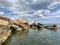 Background texture: large stones of various shapes in the sea. A pile of granite boulders against the background of the sea and