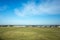 Background texture of large vacant land and residential houses in the distance. Concept of real estate development