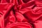 Background, texture, pattern Red Silk cloth of abstract backgrounds or wavy folds or satiny silk texture satin velvet material or