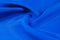 Background texture, pattern. Thick thick silk fabric of blue col