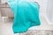 Background texture of plush fabric in aquamarine green color, background pattern of soft woolen material that lies on a small sofa