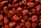 Background texture of red annato seeds used in mexican cooking achiote paste and for coloring foods