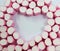 background, texture, rows of pink and white marshmallows in the shape of a heart, space for text