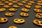 Background texture of salted savory mini pretzels in the traditional looped knot shape on the black background. Perspective