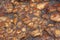 Background texture of surface of wall made of brown rounded stones.