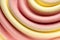 Background texture of swirling strawberry and vanilla ice cream with a ridged pattern