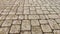 Background and texture of tiles on the sidewalk. The sidewalk on the street is made of pieces of tile or brick. Gray