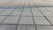 Background and texture of tiles on the sidewalk. The sidewalk on the street is made of pieces of tile or brick. Gray