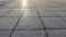 Background and texture of tiles on the sidewalk and sun in sunset. The sidewalk on the street is made of pieces of tile