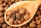 Background texture of whole allspice(jamaica pepper) with wooden spoon Used as a spice in cuisines all over the world. Also used