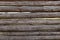 Background texture of a wooden fence of logs.