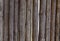 Background texture of a wooden fence of logs. Brown logs interconnected vertically.