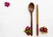 Background texture wooden spoon, wooden chopsticks and colorful pink red flowers cosmos arrangement flat lay style