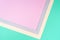 Background in trendy green and pink colors. Fashionable paper. Top view. Minimal concept. Trendy mint color