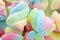 Background of twisted, colorful marshmallow, close up, macro