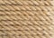 Background twisted rope. Rope texture. Brown and yellow rope texture. Old vintage sailboat rope