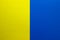 Background of two vertical rectangles yellow and blue. Sheets of blank yellow and blue paper with fine texture, split vertically,