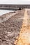 Background urban vertical design yellow line asphalt leaves into the distance pier sea dividing strip