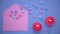 Background for Valentine's Day. View from above. Pink envelope and colorful hearts. Red candles are burning, a blue