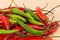 Background vegetable long green pods contrast with red close-up a lot of whole fruit