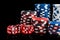 Background vertical rows of different poker chips and red dice stand on a black background
