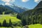 Background view of the mountain peaks of the Alps and high-speed road in the mountains