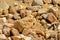 Background of volcanic pebbles on a rock beach in Portalegre, Portugal