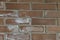 Background of wall made of red building bricks with fragments of white paint and spots