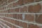 Background of wall made of red building bricks with fragments of white paint and spots