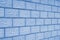 Background or wallpaper on a construction theme. The wall of the house is made of concrete blocks. Blue tinted backdrop. The