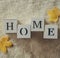 Background with warm sweaters and the inscription HOME. Pile of knitted clothes with autumn leaves, knitwear, Autumn concept.